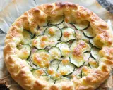 Deliziosa torta salata con zucchine, formaggio fuso e croccante pasta sfoglia. Perfetta per un pranzo leggero o un aperitivo.