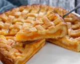 Deliziosa crostata senza glutine con ripieno di albicocche, una fetta sollevata da una paletta mostra la morbidezza.