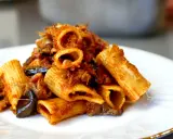 Piatto di pasta e melanzane alla napoletana, con rigatoni ricchi di sugo e melanzane fritte.