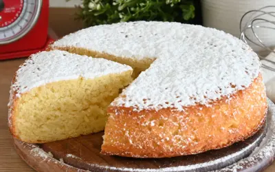 Una fetta di torta allo yogurt soffice, cosparsa di zucchero a velo, pronta per essere gustata.