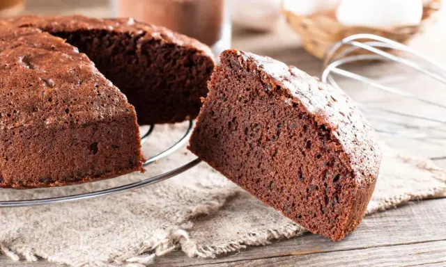 Una fetta di torta alla nutella soffice e golosa, appena sfornata, su una griglia di raffreddamento.
