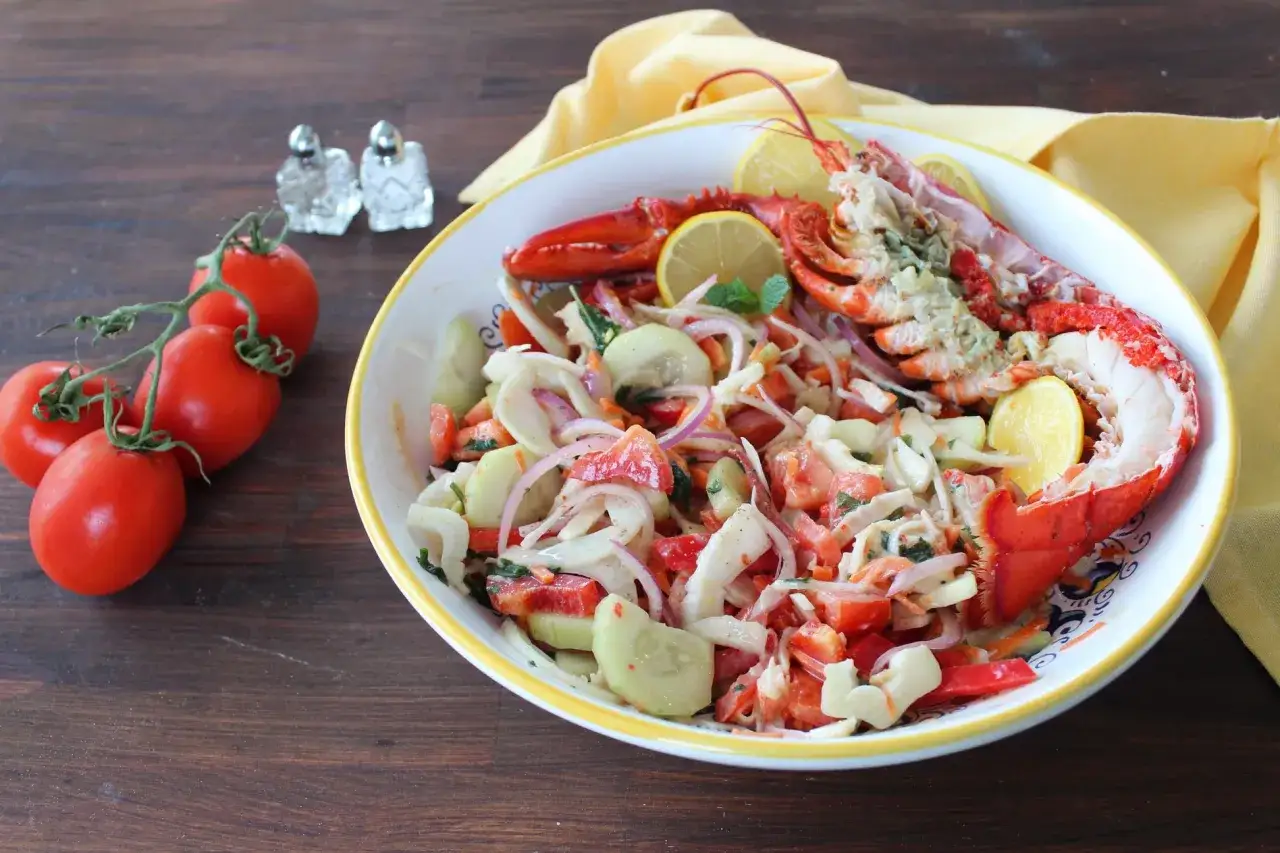 Un invitante astice alla catalana, un'esplosione di sapori freschi con pomodori, cetrioli, cipolla rossa e limone.