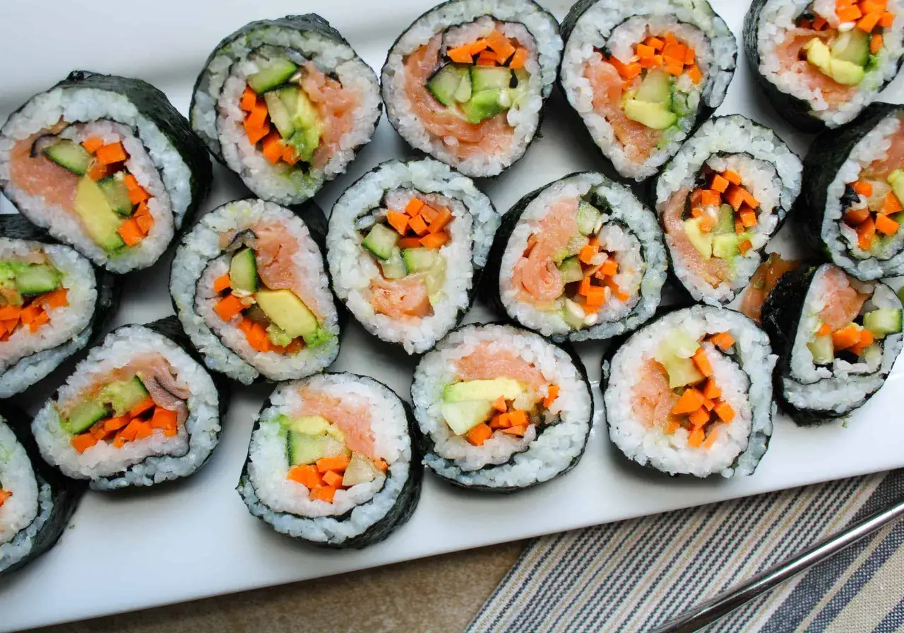 Un piatto di sushi fatto in casa con salmone, cetriolo e carota.