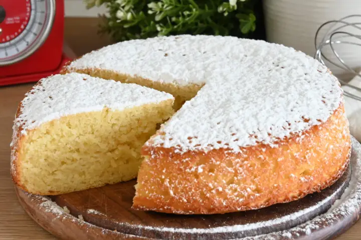 Una fetta di torta allo yogurt soffice, cosparsa di zucchero a velo, pronta per essere gustata.
